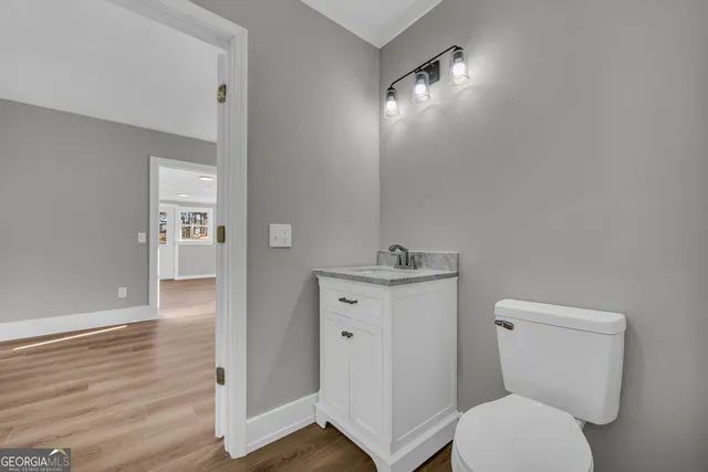 a bathroom with a toilet a sink and mirror