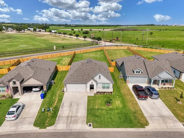 an aerial view of a house with a swimming pool