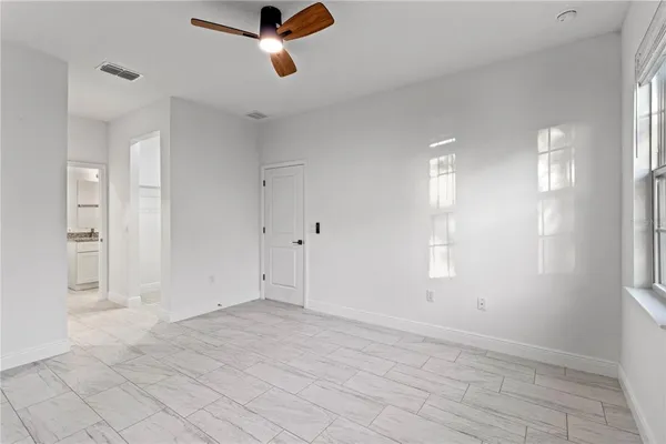 an empty room with windows and closet