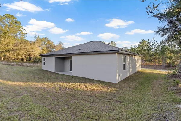 a view of a house with a backyard