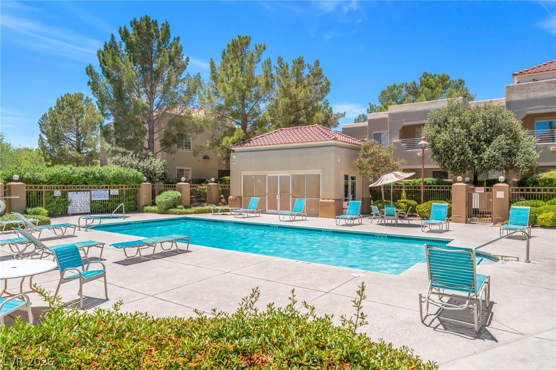 1901 Rio Canyon Court, Unit 102 Las Vegas, NV 89128 - Photo 23 of 23 A refreshing pool area invites relaxation with ample lounging space and manicured surroundings.