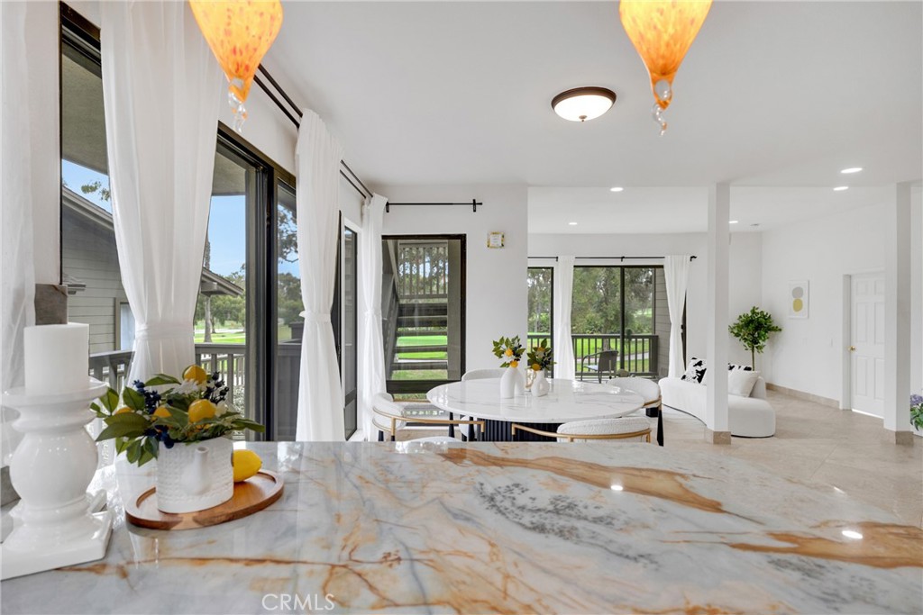 20 Nuevo, Unit 10 Irvine, CA 92612 - Photo 12 of 36 a living room with furniture potted plant and a large window