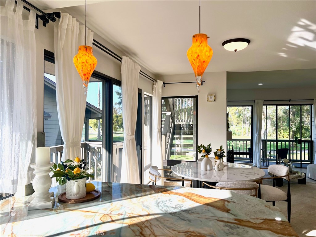 20 Nuevo, Unit 10 Irvine, CA 92612 - Photo 13 of 36 a living room with furniture and floor to ceiling windows