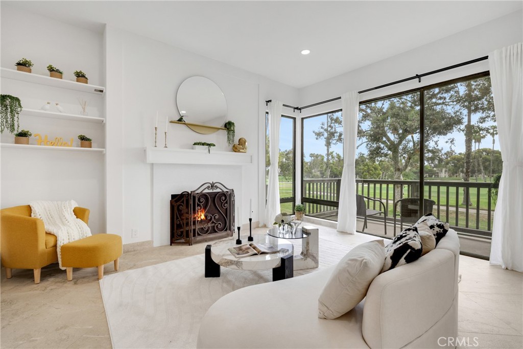 20 Nuevo, Unit 10 Irvine, CA 92612 - Photo 17 of 36 a living room with furniture large window and a fireplace