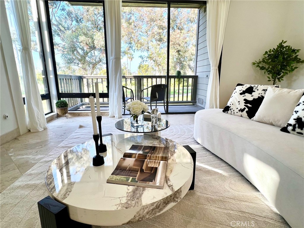 20 Nuevo, Unit 10 Irvine, CA 92612 - Photo 22 of 36 a living room with furniture and a large window