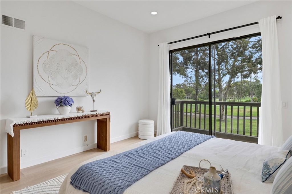 20 Nuevo, Unit 10 Irvine, CA 92612 - Photo 27 of 36 a bedroom with a bed and a large window