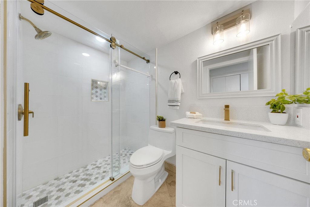 20 Nuevo, Unit 10 Irvine, CA 92612 - Photo 32 of 36 a bathroom with a sink a toilet and shower