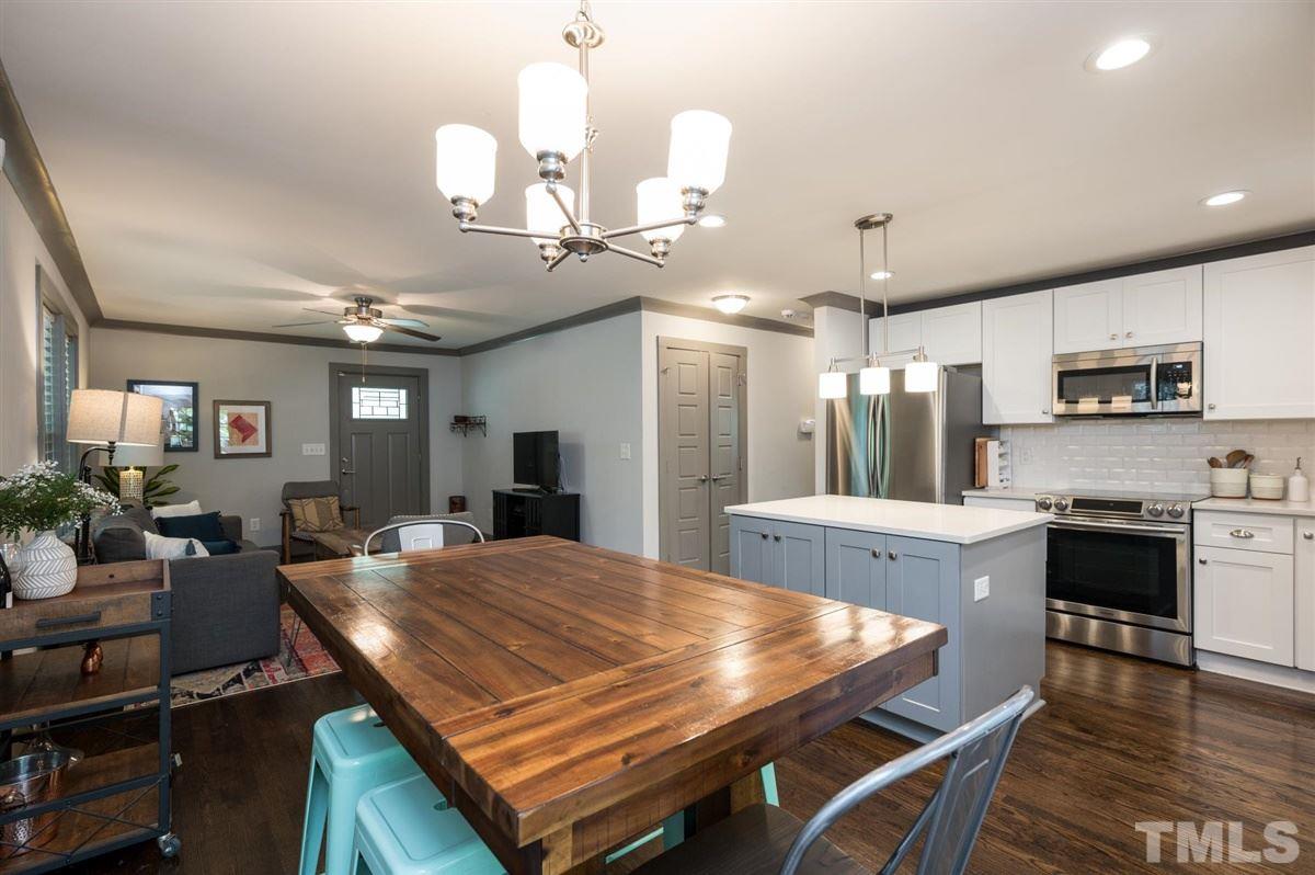 2446 Stevens Road Raleigh, NC 27610 - Photo 17 of 30 a large kitchen with kitchen island a dining table and chairs
