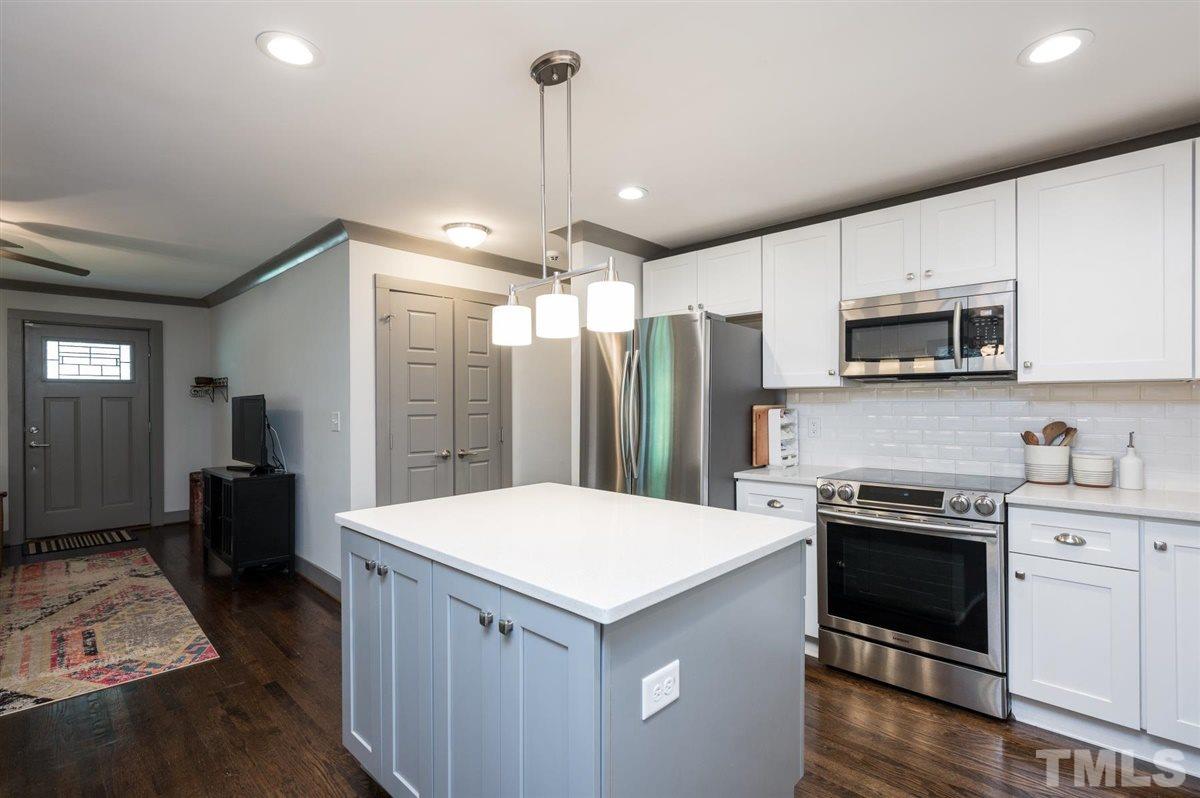2446 Stevens Road Raleigh, NC 27610 - Photo 18 of 30 a kitchen with kitchen island a sink stainless steel appliances and cabinets