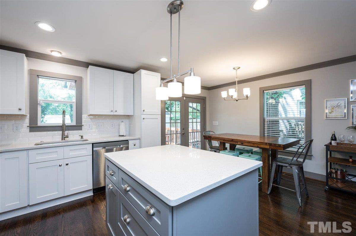 2446 Stevens Road Raleigh, NC 27610 - Photo 20 of 30 a kitchen with a stove a window and chairs