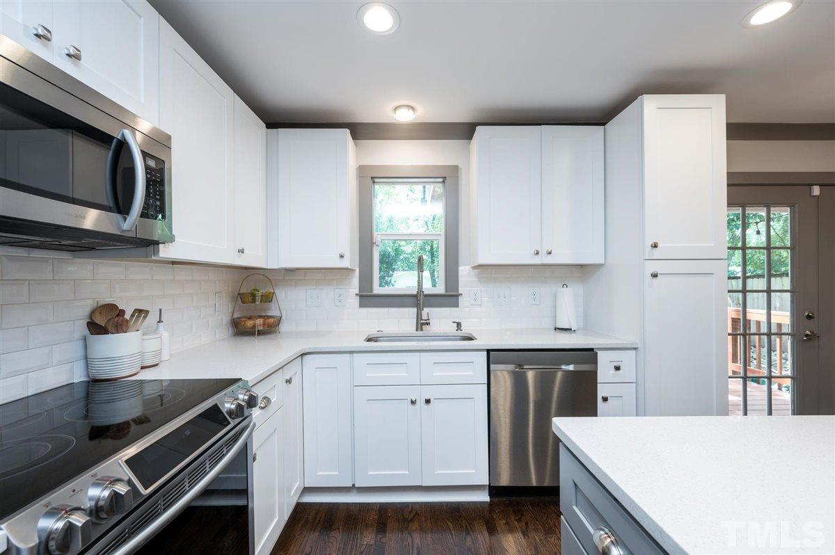 2446 Stevens Road Raleigh, NC 27610 - Photo 21 of 30 a kitchen with a sink stove and cabinets