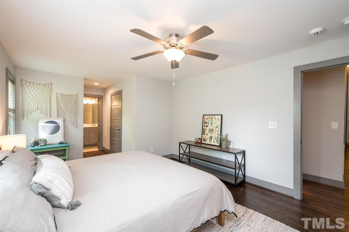 2446 Stevens Road Raleigh, NC 27610 - Photo 23 of 30 a bedroom with a bed and a chandelier
