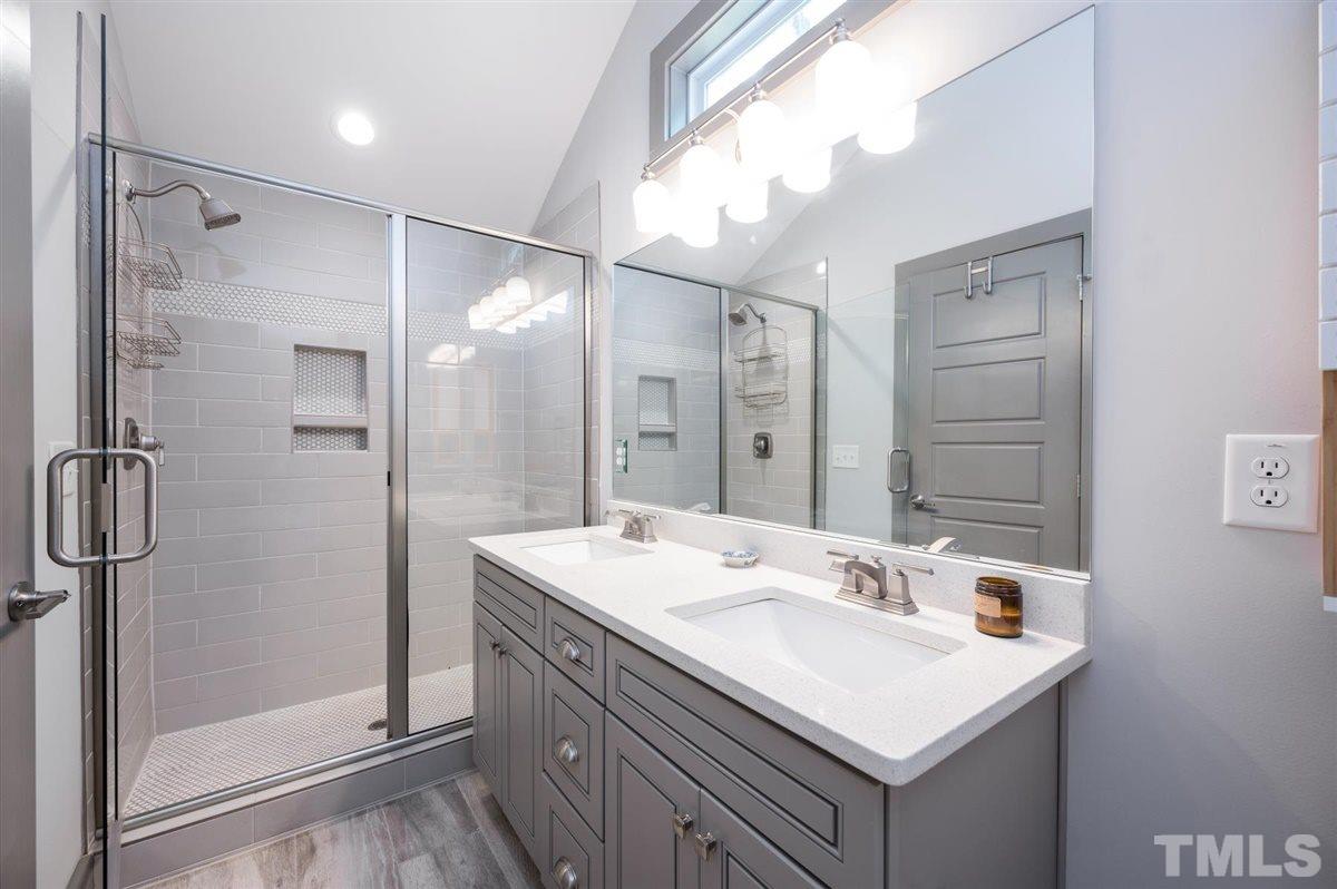 2446 Stevens Road Raleigh, NC 27610 - Photo 24 of 30 a bathroom with a sink shower and a mirror
