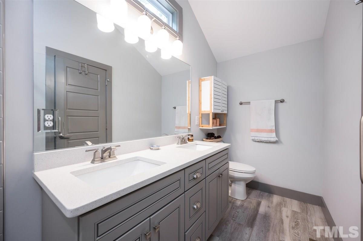 2446 Stevens Road Raleigh, NC 27610 - Photo 25 of 30 a bathroom with a sink a toilet and a mirror