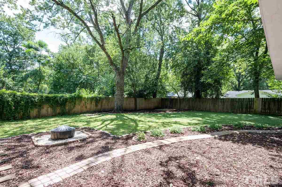 2446 Stevens Road Raleigh, NC 27610 - Photo 6 of 30 a backyard of a house with lots of green space and plants