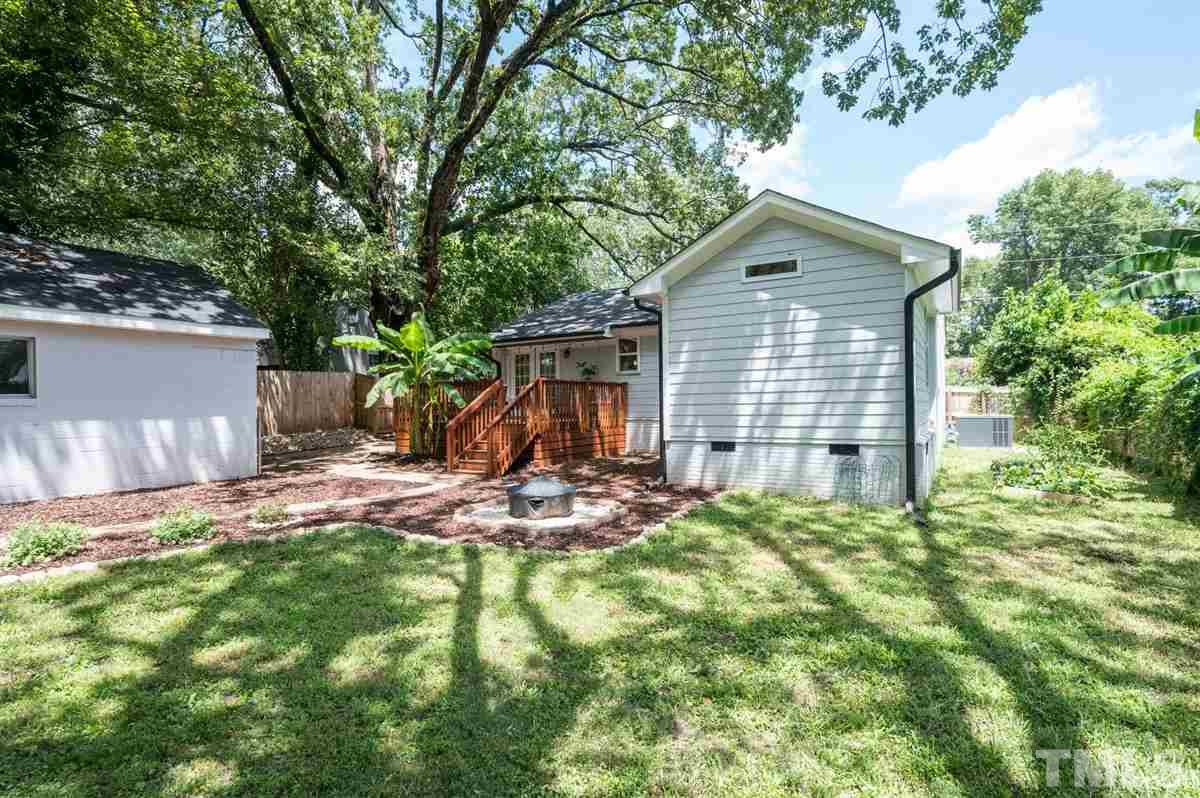 2446 Stevens Road Raleigh, NC 27610 - Photo 8 of 30 a backyard of a house with fountain table and chairs