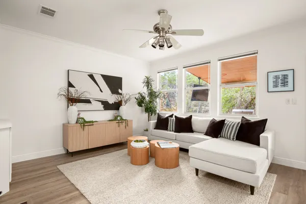a kitchen with stainless steel appliances granite countertop wooden floors and white cabinets