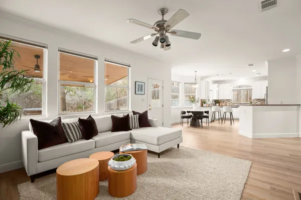 a living room with furniture a flat screen tv and a fireplace