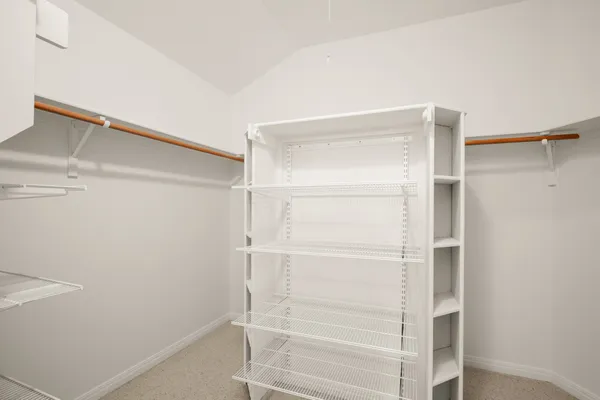 a bed room with furniture and mirror
