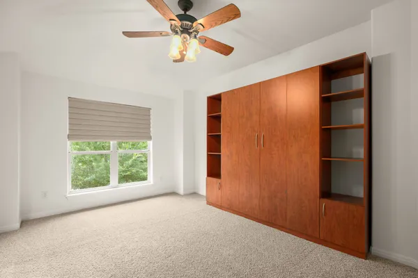 a view of walk in closet with empty racks