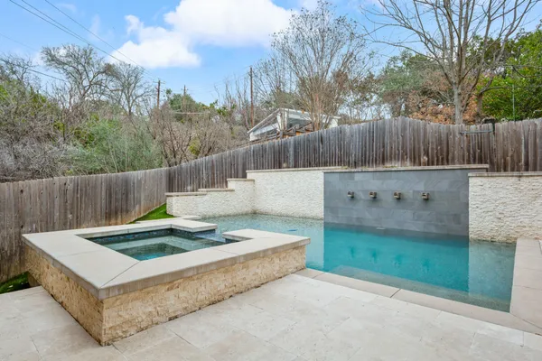 a view of a backyard with wooden fence