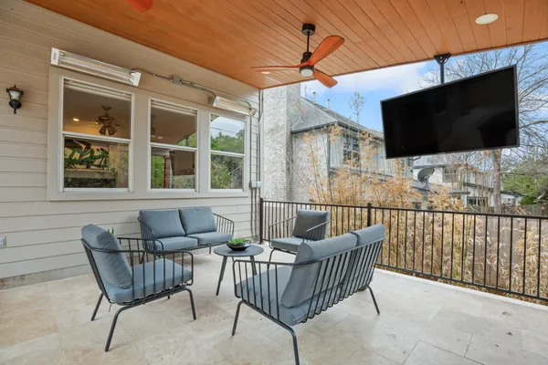 a outdoor space with lots of tables a chairs and a fireplace
