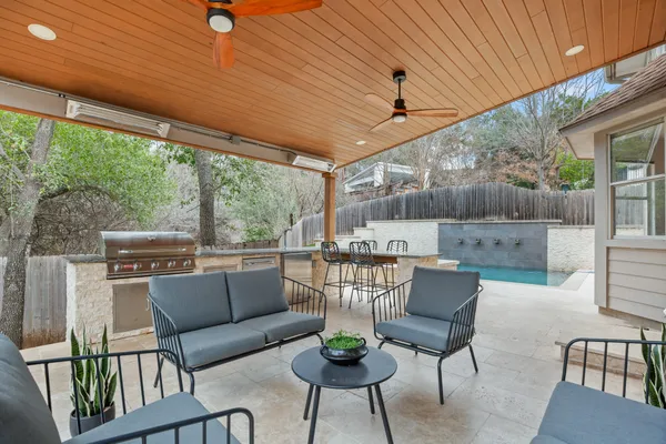 a view of a chair and tables in the back yard of the house