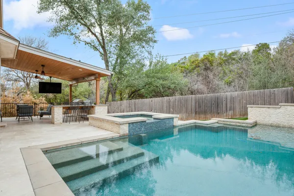 a view of swimming pool with outdoor seating and plants