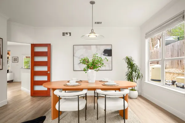 a dining room with furniture window and wooden floor