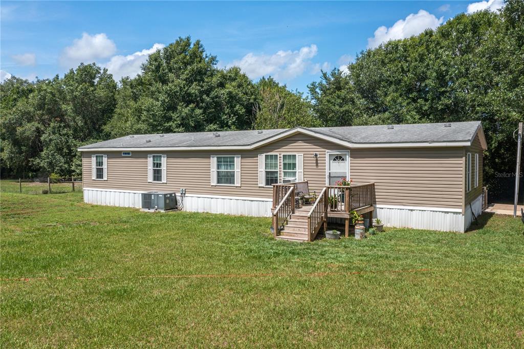15079 Brahma Road Polk City, FL 33868 - Photo 1 of 40 a front view of house with yard and seating area