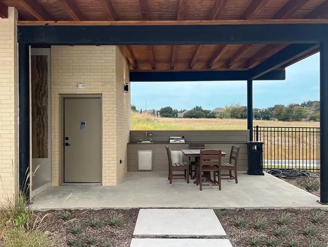 a view of a patio with a table chairs and balcony