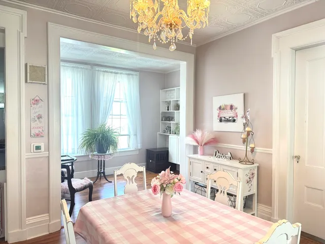 a living room with furniture and a chandelier