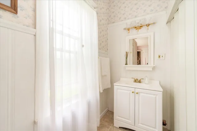 a bathroom with a sink a mirror and a shower
