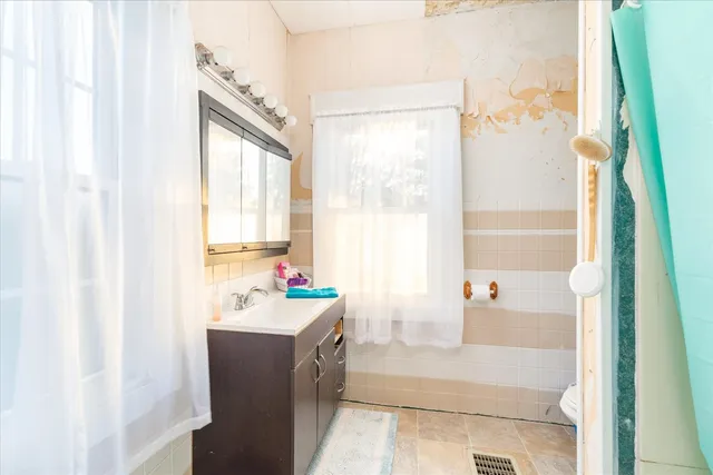 a bathroom with a bathtub sink and mirror