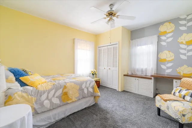 a bedroom with a bed dresser and a window