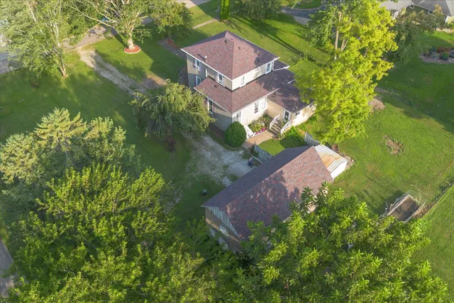 an aerial view of a house with a yard