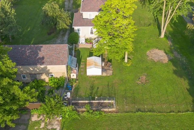 an aerial view of a house with a yard