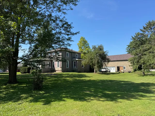 a big yard with table and trees
