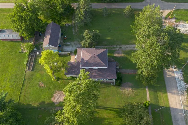 an aerial view of a house with a yard