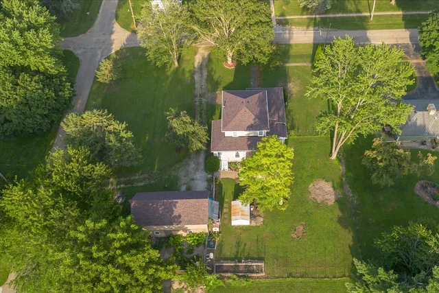 an aerial view of a house with a yard