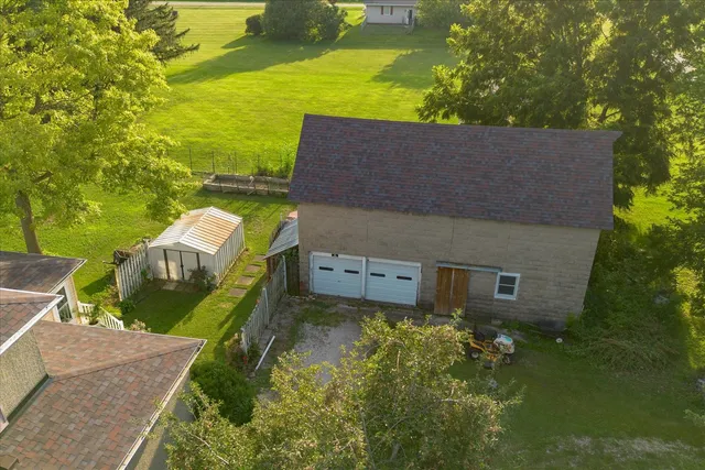 an aerial view of a house with a yard basket ball court and outdoor seating