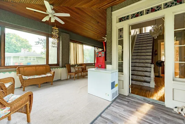 a living room with furniture and a floor to ceiling window