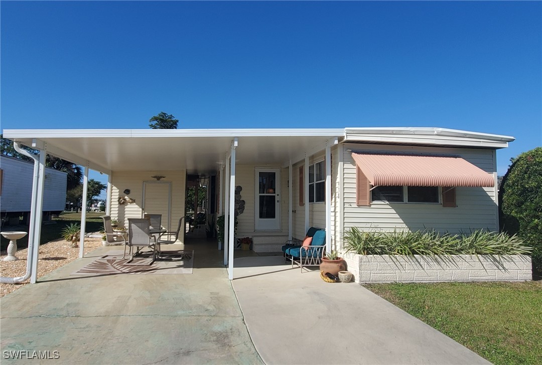 938 Lazy Lane North Fort Myers, FL 33917 - Photo 1 of 37 a view of a house with backyard porch and sitting area