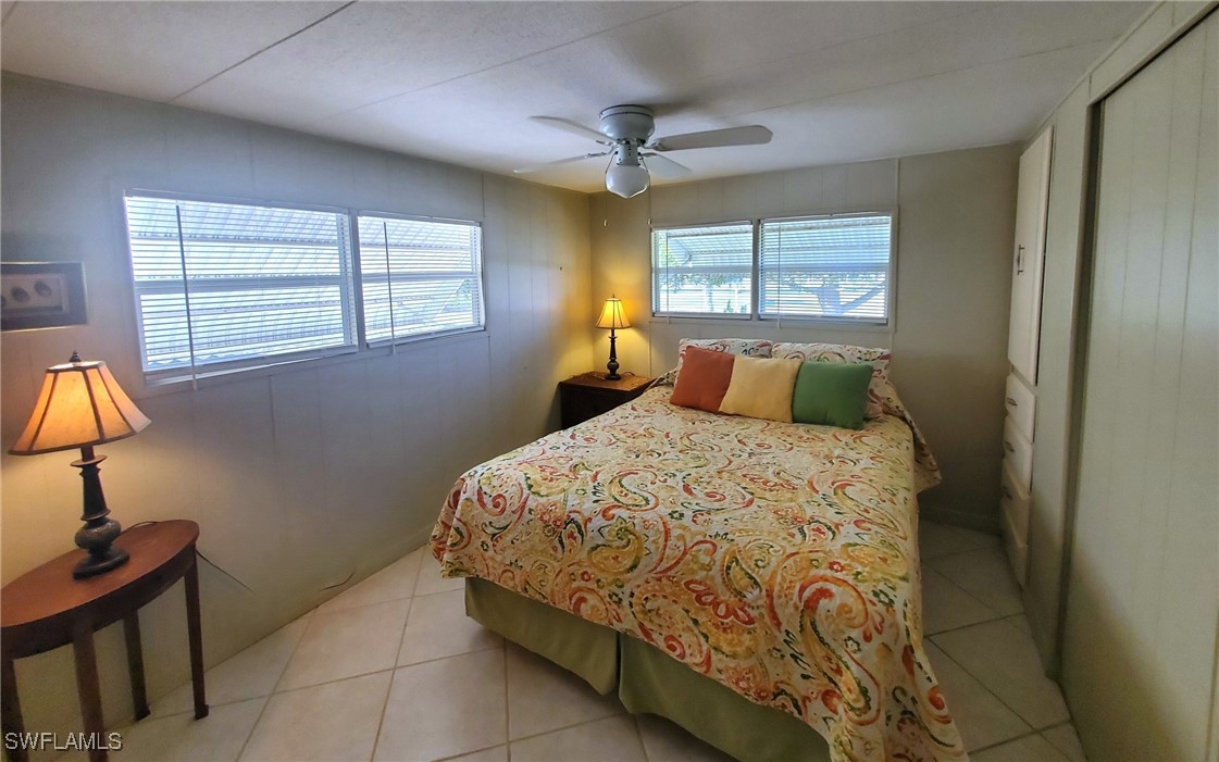 938 Lazy Lane North Fort Myers, FL 33917 - Photo 12 of 37 a bedroom with a bed and lamp with window