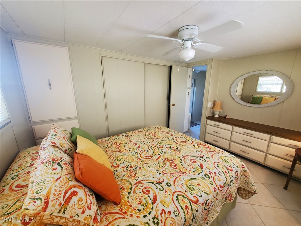 938 Lazy Lane North Fort Myers, FL 33917 - Photo 13 of 37 a bedroom with a bed and a dresser