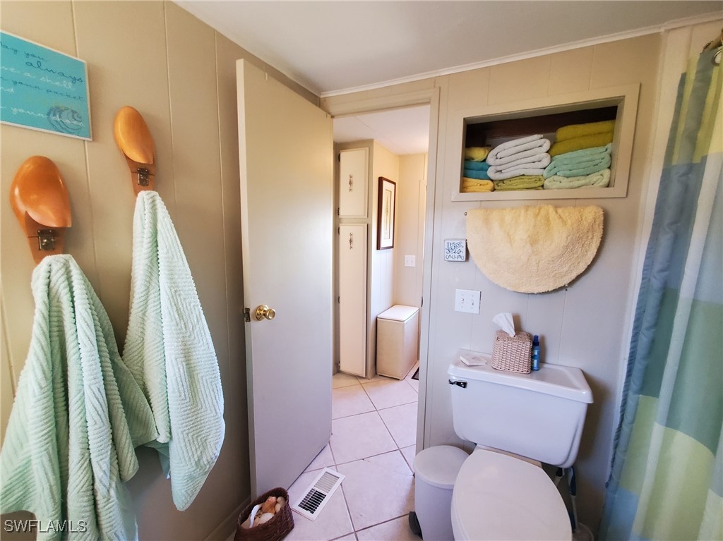 938 Lazy Lane North Fort Myers, FL 33917 - Photo 16 of 37 a bathroom with a toilet sink and mirror