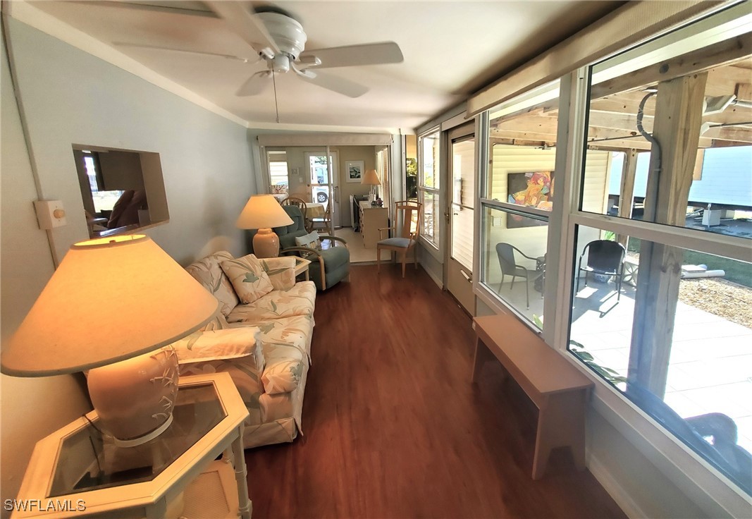 938 Lazy Lane North Fort Myers, FL 33917 - Photo 23 of 37 a living room with furniture a chandelier and a large window