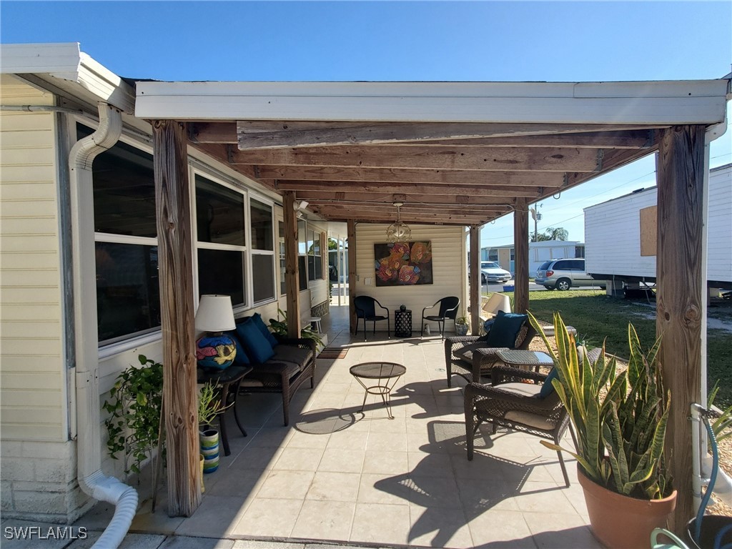 938 Lazy Lane North Fort Myers, FL 33917 - Photo 24 of 37 a living room with patio furniture and a potted plant