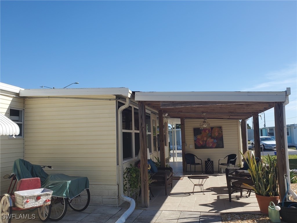 938 Lazy Lane North Fort Myers, FL 33917 - Photo 27 of 37 a view of a patio with couple of chairs and potted plants