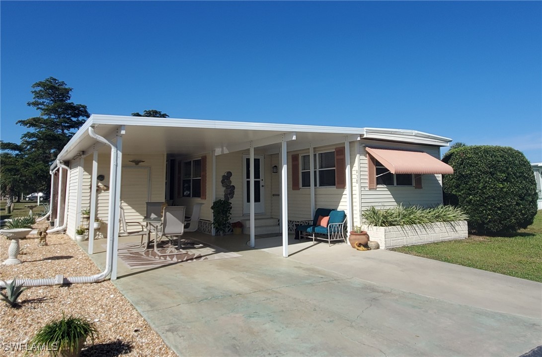 938 Lazy Lane North Fort Myers, FL 33917 - Photo 3 of 37 a front view of a house with a garden and plants